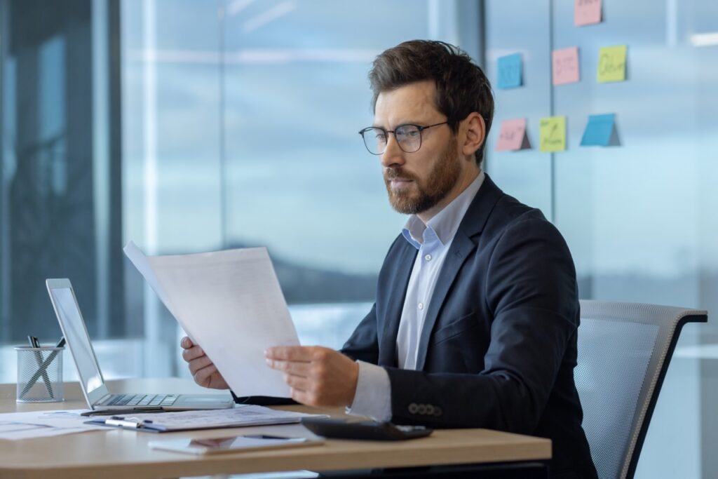 Asset manager evaluating SatuitCRM vs Infor CRM on a laptop