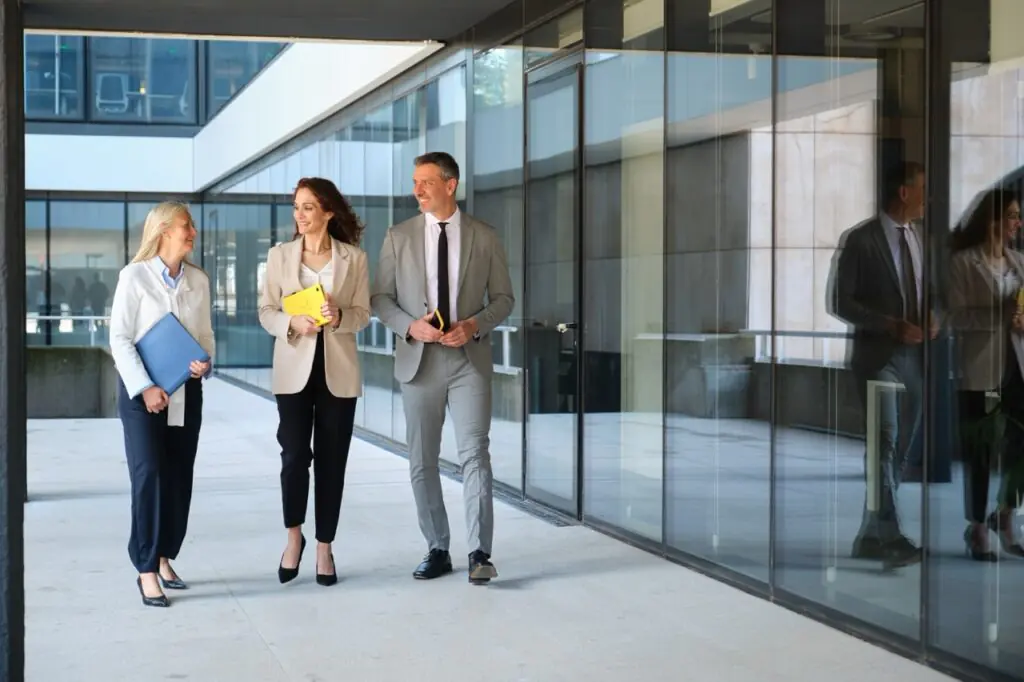 Multi-family office team walking outside a modern office building, reflecting CRM for multi-family offices