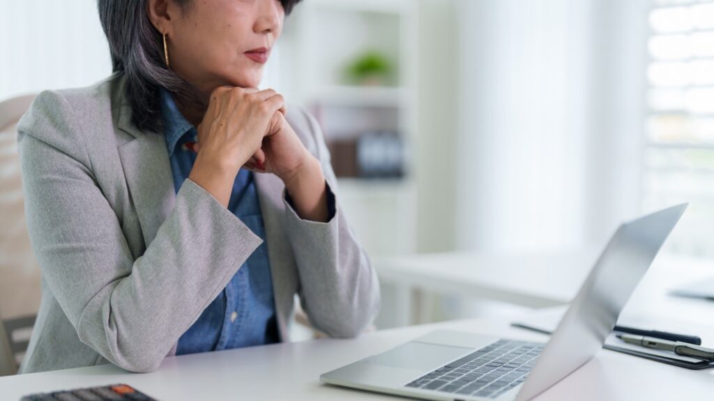 Businesswoman deep in thought weighing the hidden CRM switching cost for her investment firm
