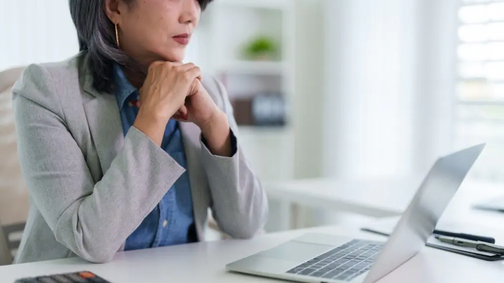 Businesswoman deep in thought weighing the hidden CRM switching cost for her investment firm